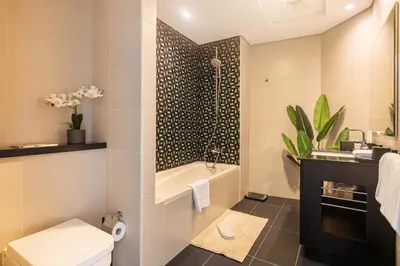 a bathroom with a toilet and a sink at Luxury 2BR in Cayan Tower with Sea, Marina & Dubai Eye View in Dubai