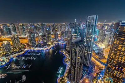 a view of a city at night at Luxury 2BR in Cayan Tower with Sea, Marina & Dubai Eye View in Dubai