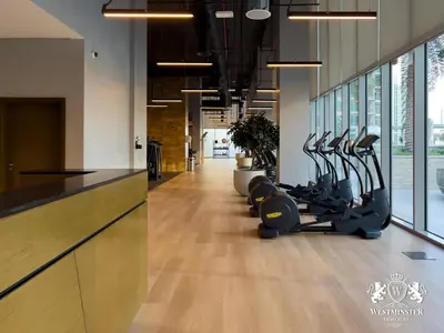 a gym with treadmills and ellipticals in a hallway at Westminster Forte Burj Khalifa in Dubai