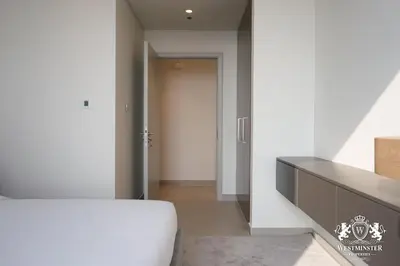 a bedroom with a white bed and a door at Westminster Forte Burj Khalifa in Dubai