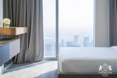 a bedroom with a bed and a large window at Westminster Forte Burj Khalifa in Dubai