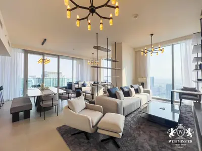 a living room with white furniture and a dining room at Westminster Forte Burj Khalifa in Dubai