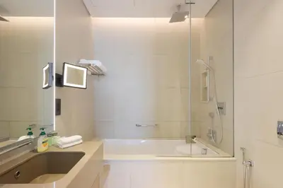 a bathroom with a tub and a sink and a shower at 1BHK with Marina Views and Beach Access in Dubai