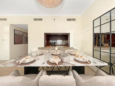 a dining room with a table and two chairs at Royal Vista - Luxury 2BR Apartment at Burj Views Tower A - Downtown in Dubai