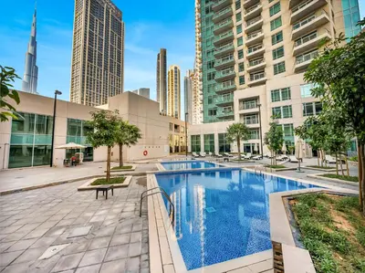 a pool in the middle of a city with tall buildings at Royal Vista - Luxury 2BR Apartment at Burj Views Tower A - Downtown in Dubai