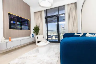a bedroom with a blue bed and a window at Burj Khalifa View Pool Gym 10 Min To Downtown in Dubai