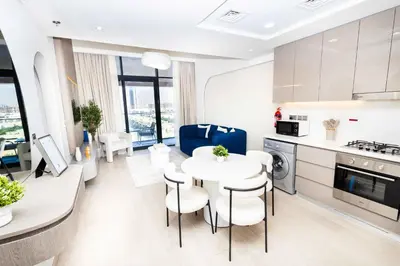 a kitchen and dining room with a table and chairs at Burj Khalifa View Pool Gym 10 Min To Downtown in Dubai