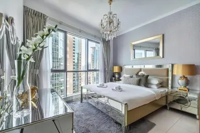 a bedroom with a bed and a large window at GuestReady - Charming stay with Burj Khalifa views in Dubai