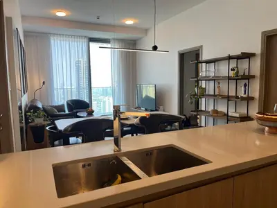 a kitchen with a sink and a living room at Dubai Marina stunning views holiday apartment Stella Maris Tower in Dubai