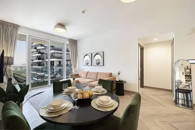 a living room with a table and a couch at Chic 2 Bed Near Trade Centre with 5 Star Amenities in Dubai