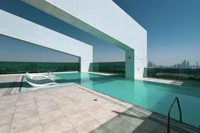 a building with a swimming pool on the roof at Chic 2 Bed Near Trade Centre with 5 Star Amenities in Dubai