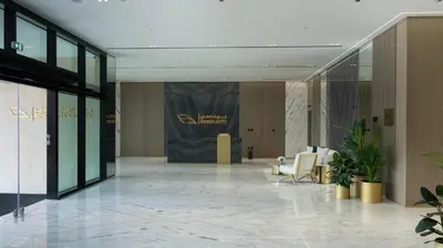 a lobby with chairs and a sign in a building at Modern 1br In Jvc Pool, Balcony & Free Parking in Dubai