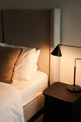 a bedroom with a bed and a lamp on a table at Luxury Seaview 2BR - Paramount Midtown - 6 Guests - 64F Pool Access & Burj View in Dubai