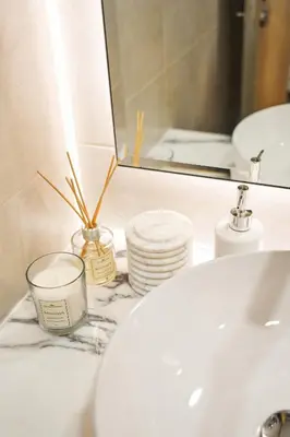 a bathroom counter with a sink and a mirror at Luxury Seaview 2BR - Paramount Midtown - 6 Guests - 64F Pool Access & Burj View in Dubai