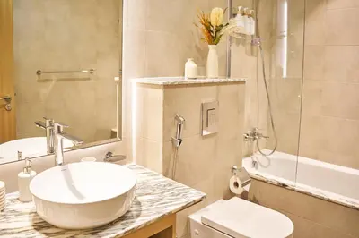 a bathroom with a sink and a toilet and a shower at Luxury Seaview 2BR - Paramount Midtown - 6 Guests - 64F Pool Access & Burj View in Dubai