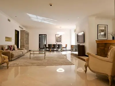 a living room with a couch and a table at Spacious 4BR Duplex with Terrace - JBR in Dubai