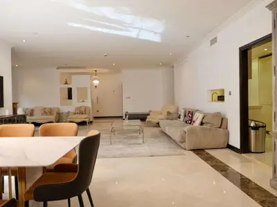 a living room with couches and a dining room at Spacious 4BR Duplex with Terrace - JBR in Dubai