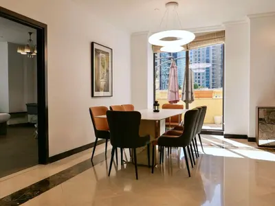a dining room with a table and chairs at Spacious 4BR Duplex with Terrace - JBR in Dubai