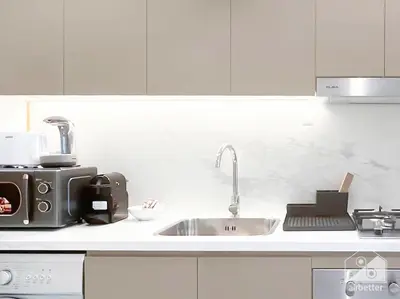 a kitchen counter with a sink and a microwave at Elegant Stay in Meydan Balcony & Stunning Views in Dubai