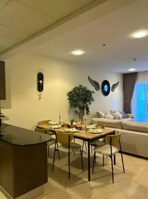 a living room with a table and a couch at 1BHK in Dubai Marina near tram in Dubai