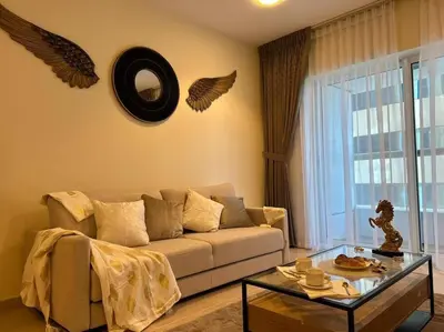 a living room with a couch and a glass table at 1BHK in Dubai Marina near tram in Dubai