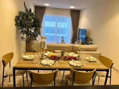a table in a living room with a table and chairs at 1BHK in Dubai Marina near tram in Dubai