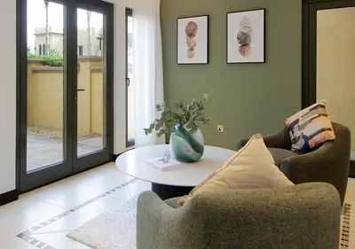 a living room with two chairs and a table at Cozy 4BR Maid Villa at Canal Cove Palm Jumeirah in Dubai
