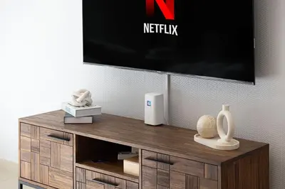 a wooden entertainment center with a tv on a wall at Dubai Mall Connected! AMAZING Burj Khalifa View! Excellent Pool & Gym Access! in Dubai