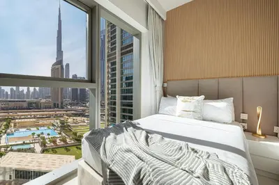 a bedroom with a bed and a large window at Dubai Mall Connected! AMAZING Burj Khalifa View! Excellent Pool & Gym Access! in Dubai