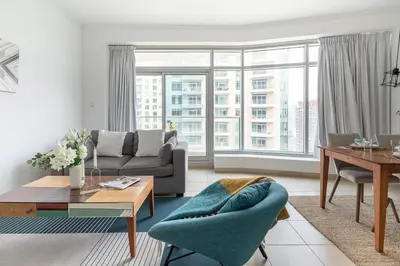 a living room with a couch and a table at Frank Porter - Burj Views West in Dubai