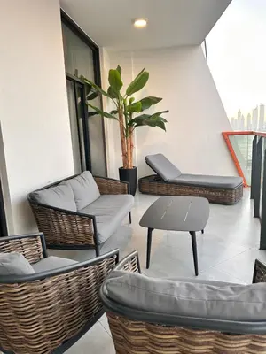 a patio with chairs and a table and a plant at Close to burj khalifa nice place in Dubai