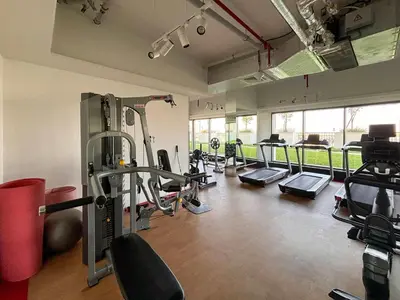 a gym with treadmills and machines in a room at Frank Porter - Wavez Residence in Dubai