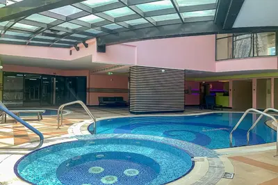 a large swimming pool in a building at Frank Porter - Time Place Tower in Dubai