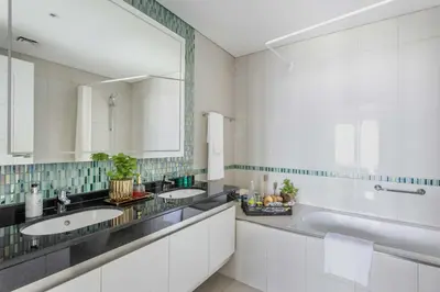 a bathroom with two sinks and a large mirror at Frank Porter - Damac Heights in Dubai