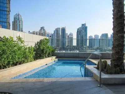 a swimming pool with a city skyline in the background at Frank Porter - Damac Heights in Dubai