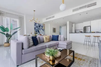 a living room with a couch and a table at Frank Porter - Damac Heights in Dubai