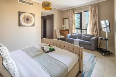 a bedroom with a bed and a living room at Frank Porter - The Residences Tower 8 in Dubai