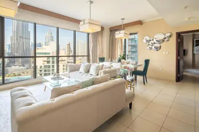 a living room with a couch and a table at Frank Porter - The Residences Tower 8 in Dubai