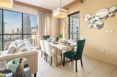 a living room with a table and a couch at Frank Porter - The Residences Tower 8 in Dubai