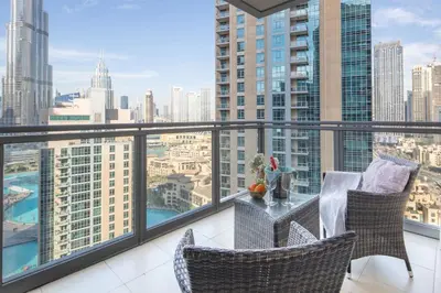 a balcony with a table and chairs and a view of the city at Frank Porter - The Residences Tower 8 in Dubai