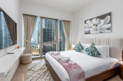 a bedroom with a bed and a large window at Near Burj Khalifa & Dubai Mall - 1BR in Grande Residence, Downtown - Allsopp & Allsopp in Dubai