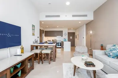 a living room with a couch and a table at Near Burj Khalifa & Dubai Mall - 1BR in Grande Residence, Downtown - Allsopp & Allsopp in Dubai