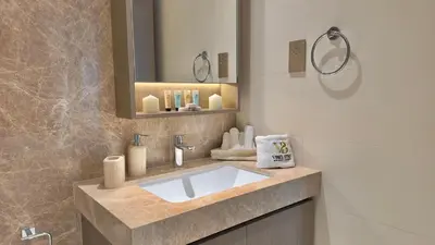 a bathroom with a sink and a mirror at Guest Favorite 1BR Designer Apt with Beach Access by Vibel in Dubai