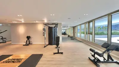 a gym with treadmills and exercise equipment in a building at Guest Favorite 1BR Designer Apt with Beach Access by Vibel in Dubai