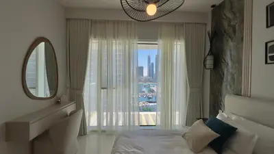 a bedroom with a bed and a large window at Guest Favorite 1BR Designer Apt with Beach Access by Vibel in Dubai