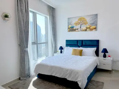 a bedroom with a bed and a large window at Stunning 1 bedroom in JBR with Balcony - Dubai Marina Mall view in Dubai