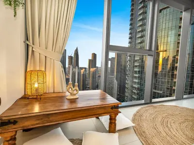 a room with a table and a window with a view at Wabi-Sabi Style Fountain-View 4 BR Apt in the Sky in Dubai