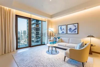 a living room with a couch and a table at Elegant 3BR at The Address Residences Dubai Opera, Downtown Dubai by Deluxe Holiday Homes in Dubai