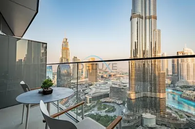 a balcony with a table and a view of a city at Elegant 3BR at The Address Residences Dubai Opera, Downtown Dubai by Deluxe Holiday Homes in Dubai