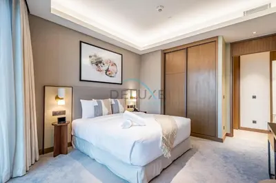 a bedroom with a large white bed in a room at Elegant 3BR at The Address Residences Dubai Opera, Downtown Dubai by Deluxe Holiday Homes in Dubai